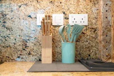 two wooden utensils in a blue cup on a table at Imperial Avenue Downtown Lux 1Bed with Balcony in Dubai