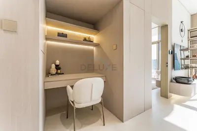 a dining room with a white chair and a table at Community View, Near the Circle Mall, Pear House II by Imtiaz, Jumeirah Village Circle by Deluxe Holiday Homes in Dubai