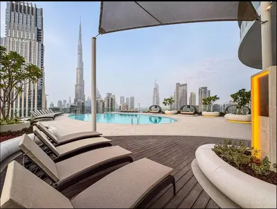 a view of a city with a pool and buildings at Luxurious 3-bedroom apartment downtown in Dubai
