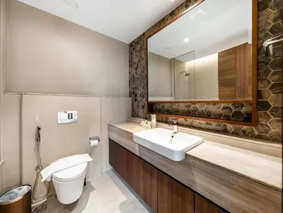 a bathroom with a sink and a toilet and a mirror at Luxurious 3-bedroom apartment downtown in Dubai