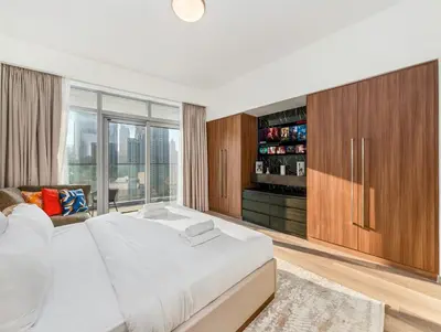 a bedroom with a large white bed and a large window at Luxurious 3-bedroom apartment downtown in Dubai