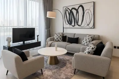 a living room with a couch and two chairs and a table at Cozy 1-Bedroom Flat in Central JVC in Dubai