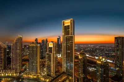 a city skyline at night with tall buildings at Vogue Downtown Opera Grand near Burj Khalifa and Dubai Mall, Two Bedroom Apartment with Large Balcony and Access to all Amenities in Dubai