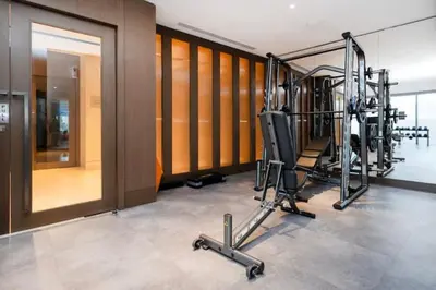 a gym with cardio equipment in a building at Vogue Downtown Opera Grand near Burj Khalifa and Dubai Mall, Two Bedroom Apartment with Large Balcony and Access to all Amenities in Dubai