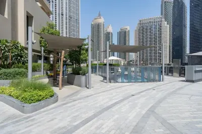 a patio with tables and umbrellas in a city at Vogue Downtown Opera Grand near Burj Khalifa and Dubai Mall, Two Bedroom Apartment with Large Balcony and Access to all Amenities in Dubai