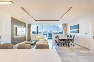 a living room with a couch and a table at Palm Home next to Nakheel Mall with Private Beach in Dubai