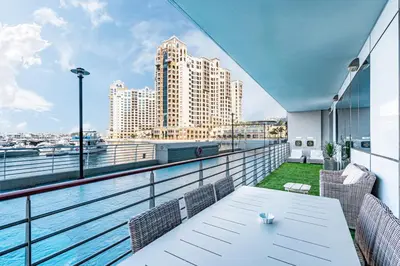 a balcony with a table and chairs and a view of a city at Palm Home next to Nakheel Mall with Private Beach in Dubai
