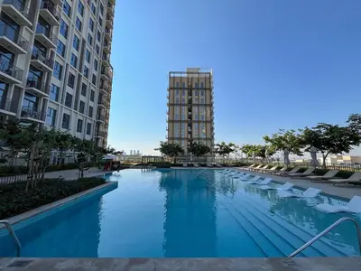 a swimming pool in the middle of a building at Chic & Modern 1BR Stay in Collective Dubai Hills in Dubai
