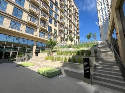 a building with stairs in front of a building at Chic & Modern 1BR Stay in Collective Dubai Hills in Dubai
