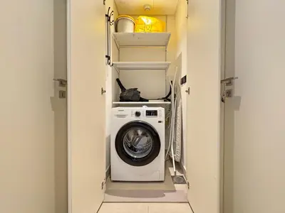 a washer and dryer in a small room at Chic & Modern 1BR Stay in Collective Dubai Hills in Dubai