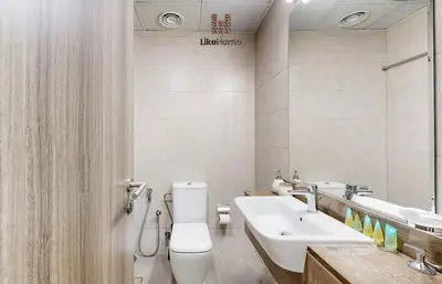 a bathroom with a toilet and a sink at Family-Friendly 2BR in Azizi Plaza with Pool & Gym in Dubai