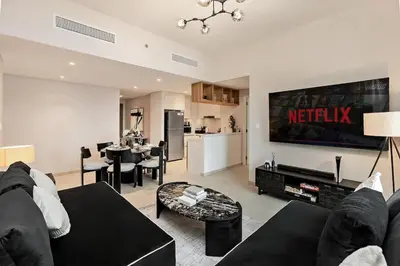 a living room with a couch and a table at Luxury 2BR Downtown Steps from Burj Khalifa in Dubai