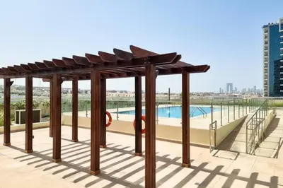 a pavilion with a swimming pool in a city at Modern Stay in Azizi Samia1BR Al Furjan in Dubai