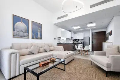 a living room with a couch and a table at Modern Stay in Azizi Samia1BR Al Furjan in Dubai