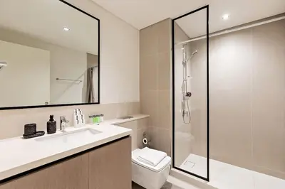 a bathroom with a toilet and a sink and a shower at Luxury 2BR Burj Crown Stay Downtown in Dubai