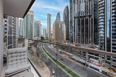 a balcony with a chair and a city street at Luxury 2BR Burj Crown Stay Downtown in Dubai
