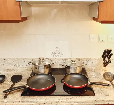 two pots and pans on a stove in a kitchen at Modern 1BR theme and Burj Khalifa View Downtown in Dubai