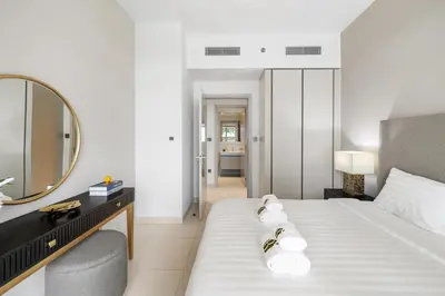 a hotel room with a bed and a mirror at BLVD-Beachfront Luxe Stay with Private Beach Access in Dubai