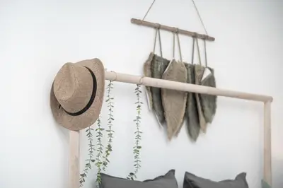 a hat and someanas hanging on a wall at HiGuests - Charming Studio with Lake Views in Business Bay in Dubai