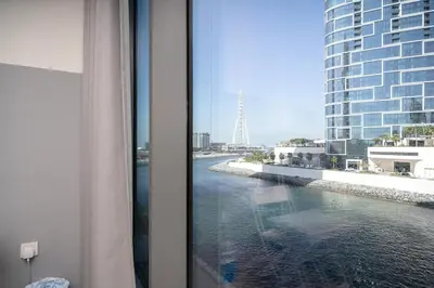 a view of a river from a hotel room window at Luxury Bluewater Escape 1BR Canal view 5242T in Dubai