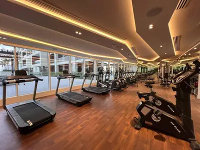 a gym with a row of treadmills and machines at Luxurious Haven Studio In Jewelz Arjan 03 in Dubai