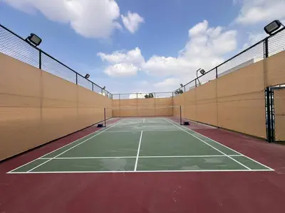 an empty tennis court with aermottermottermott at Luxurious Haven Studio In Jewelz Arjan 03 in Dubai