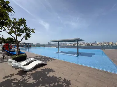 a large swimming pool with a white chair next to it at The Grand Majestic Sky Luxe 1BR Sleeps 4 06 in Dubai