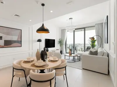 a white living room with a table and chairs at The Grand Majestic Sky Luxe 1BR Sleeps 4 06 in Dubai