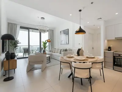 a kitchen and living room with a table and chairs at The Grand Majestic Sky Luxe 1BR Sleeps 4 06 in Dubai