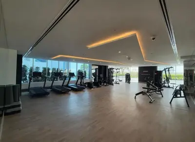 a gym with treadmills and exercise equipment in a building at Opalz Reverie Luxe Studio Escape 08 in Dubai
