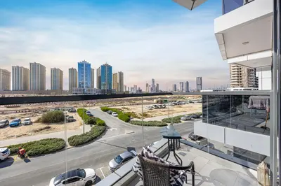 a balcony with a view of a city with tall buildings at Daniels Studio at V2 Residence, Sports City in Dubai