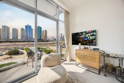 a living room with a view of a city at Daniels Studio at V2 Residence, Sports City in Dubai