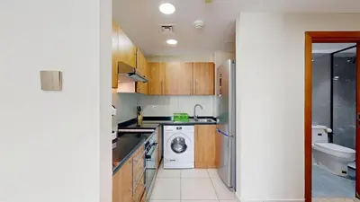 a small kitchen with a washing machine and a washer at Marina View Tower 2BR Stunning Canal Views in Dubai