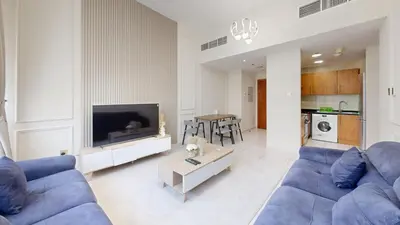 a living room with a blue couch and a tv at Marina View Tower 2BR Stunning Canal Views in Dubai