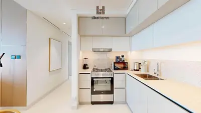 a kitchen with white cabinets and a stove top oven at Chic 2BR Getaway Marina Vista T2 Sea view in Dubai