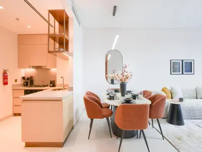a kitchen and dining room with a table and chairs at Vida Residences 2BR-Direct Dubai Mall Access in Dubai