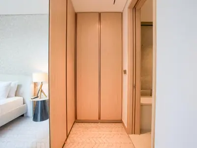 a room with a closet with a bed and a lamp at Vida Residences 2BR-Direct Dubai Mall Access in Dubai