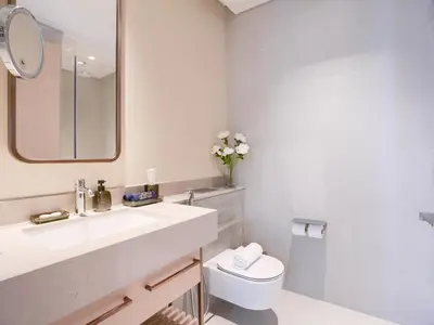 a bathroom with a sink and a toilet and a mirror at Vida Residences 2BR-Direct Dubai Mall Access in Dubai