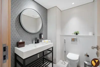 a bathroom with a white sink and a mirror at Vogue JVT Novotel near Springs Souk Mall, One Bedroom apartment with Balcony and Vibrant Community View, Access to all Amenities in Dubai