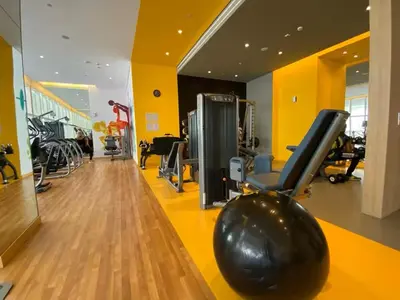 a gym with a bowling ball and exercise equipment at Vogue JVT Novotel near Springs Souk Mall, One Bedroom apartment with Balcony and Vibrant Community View, Access to all Amenities in Dubai