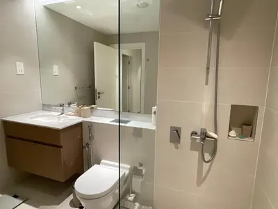 a bathroom with a shower and a toilet and a sink at La Mer Iconic View 1 bedroom in Dubai