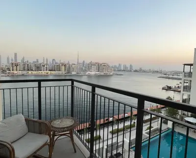 a balcony with a view of a river and buildings at La Mer Iconic View 1 bedroom in Dubai