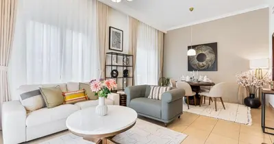 a living room with a couch and a table at Downtown 2BHK Burj View & Private Garden in Dubai