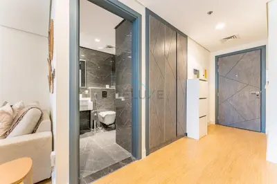 a bathroom with a shower with a glass door at Inviting Studio Overlooking the Pool, Just a Short Drive from Dubai Autodrome, Samana Golf Avenue, Dubai Studio City by Deluxe Holiday Homes in Dubai