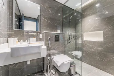 a bathroom with a sink and a shower at Inviting Studio Overlooking the Pool, Just a Short Drive from Dubai Autodrome, Samana Golf Avenue, Dubai Studio City by Deluxe Holiday Homes in Dubai