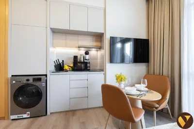 a small kitchen with a table and a microwave at Vogue JVT Novotel near Springs Souk Mall, Studio Apartment with Balcony and City View, Access to all Amenities in Dubai