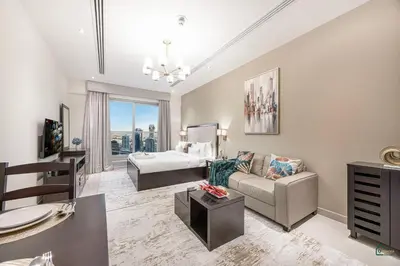 a living room with a couch and a bed at Luxury Studio Retreat! Heart of Downtown Dubai! in Sabkhah
