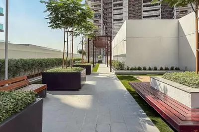 a park with benches and trees and a building at Airstay - Stylish Studio - Spacious Balcony - Monthly Offer Available! in Dubai