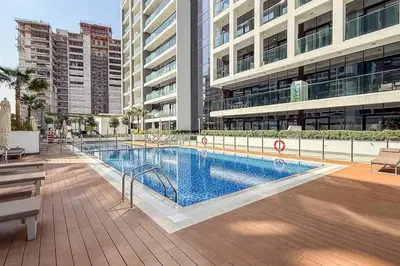 a large swimming pool in the middle of a building at Airstay - Stylish Studio - Spacious Balcony - Monthly Offer Available! in Dubai