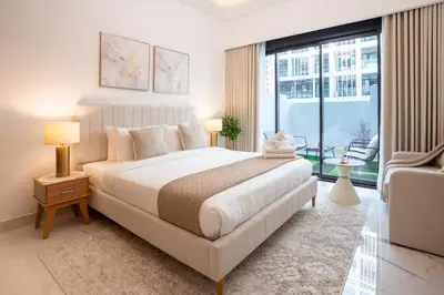 a bedroom with a large bed and a large window at Airstay - Stylish Studio - Spacious Balcony - Monthly Offer Available! in Dubai